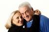 A photo of a happy retired couple embracing. A photo of a happy retired couple embracing.